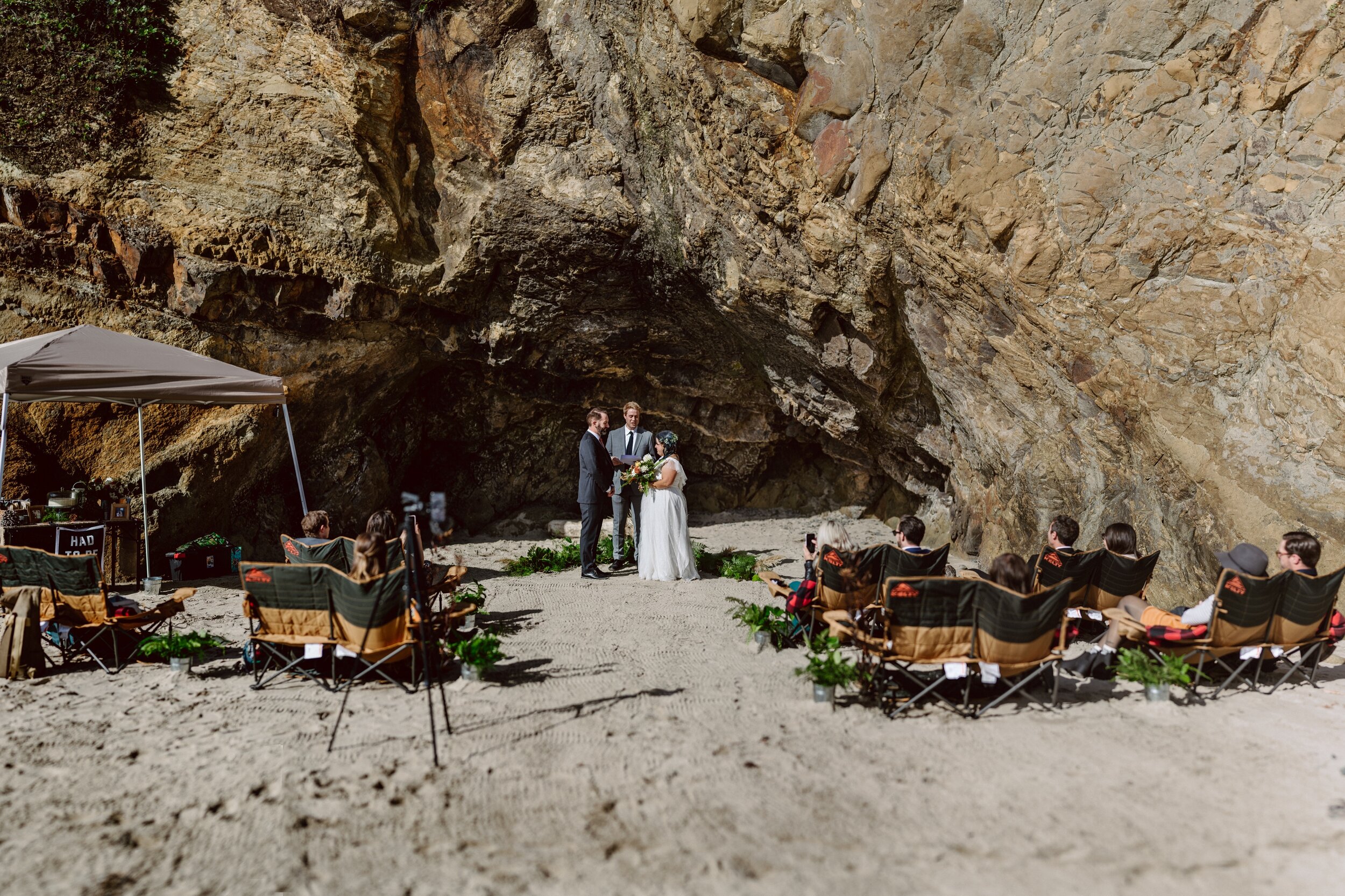 Elopement at Hug Point in Oregon with a small group of friends and a cave for the ceremony background