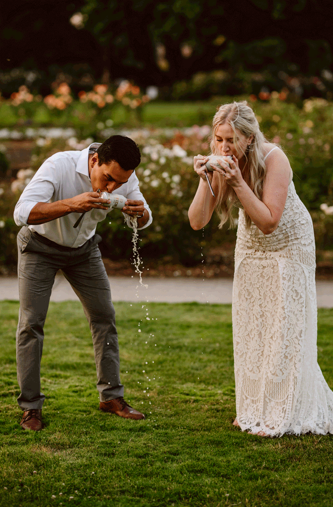 Bride and groom shotgun beers at the end of their elopement